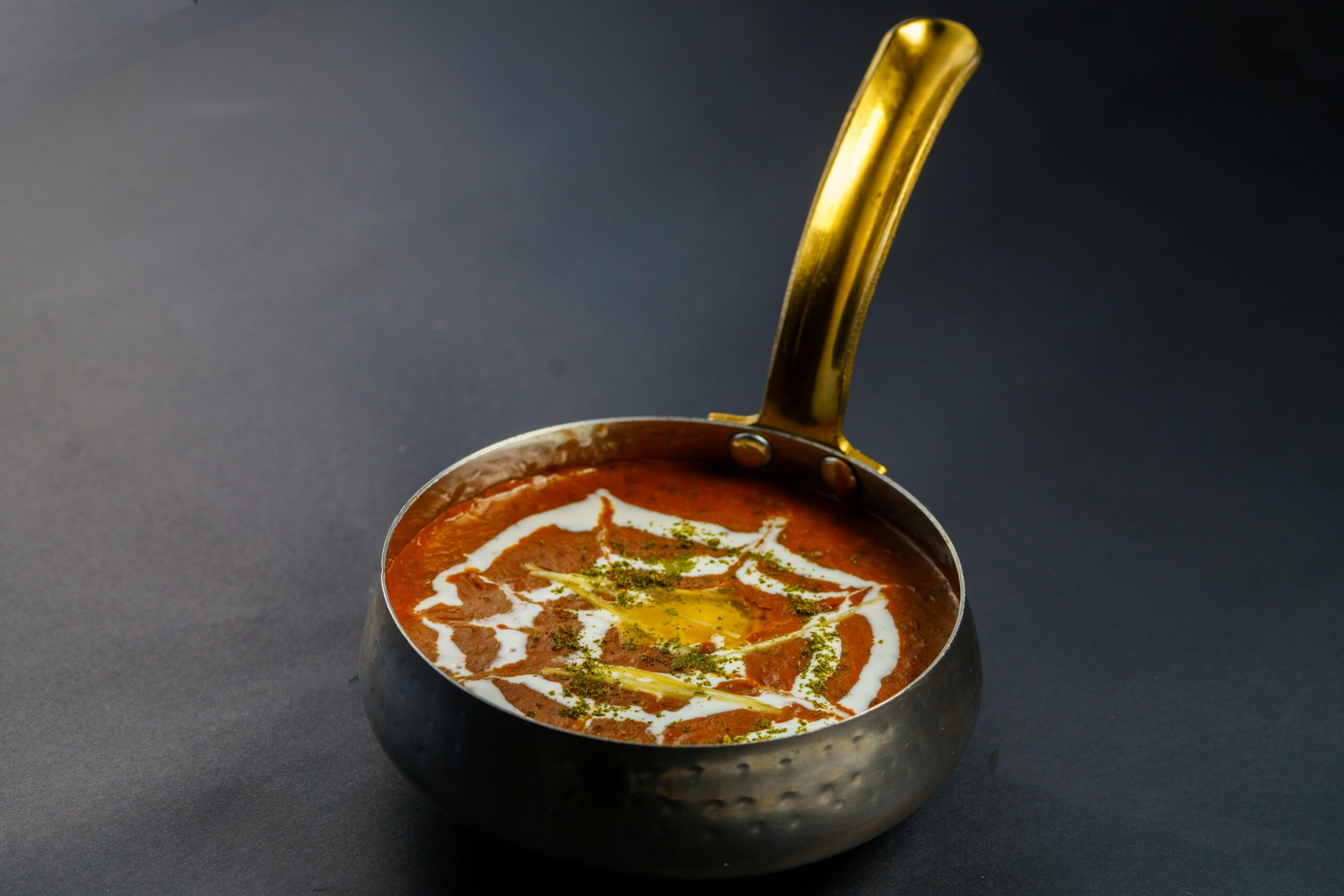 Rich and creamy dal makhani served hot in a traditional Indian pan. Perfect for food lovers.